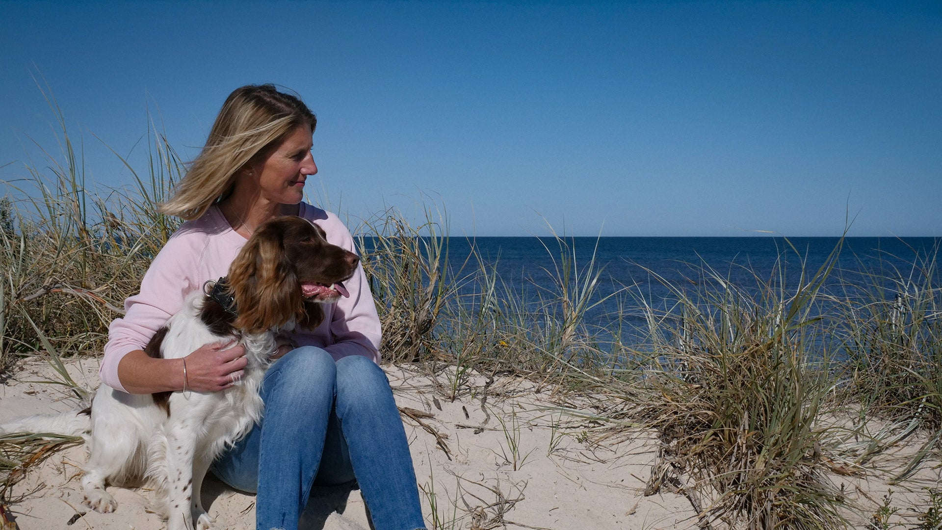 Provenance Pet Food founder and her dog Shadow on the beach